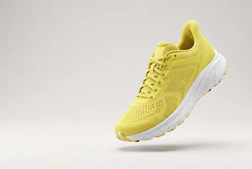 Floating Yellow Running Sneaker on Neutral Background