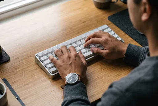 Hands Typing on Minimalist Blank Keyboard