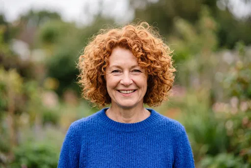 Smiling Woman With Curly Red Hair Outdoors