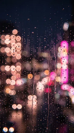 Raindrops on Window with Pink Bokeh