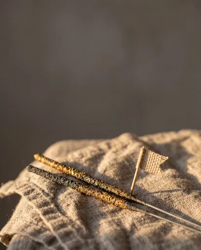 Unlit Gold Sparklers on Linen Napkin