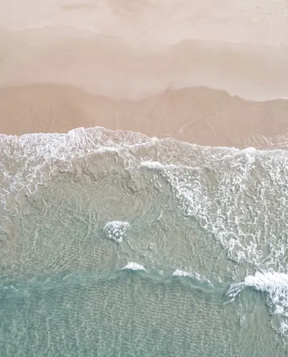 Aerial View of Ocean Waves and Beach