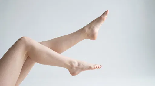 Bare Legs Raised Against Grey Studio Background