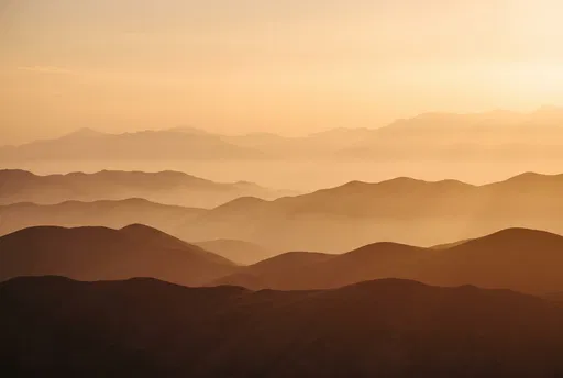 Layered Mountain Ridges in Sunset Haze