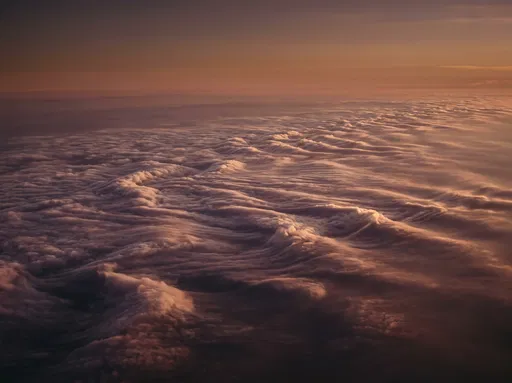 Aerial Sunset Over Wave-Like Clouds