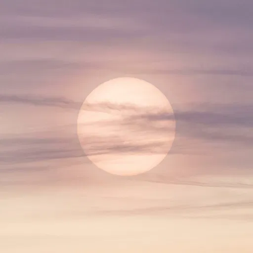 Pastel Sun Behind Soft Clouds