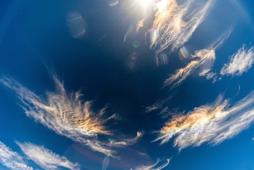 Deep Blue Sky With Sunlit Cirrus Clouds
