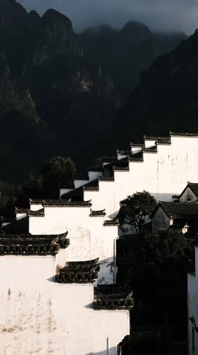 Traditional Huizhou Walls Against Dark Mountains
