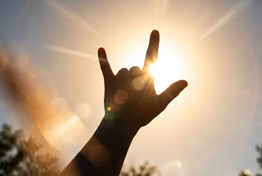Backlit Hand Forming I Love You Sign