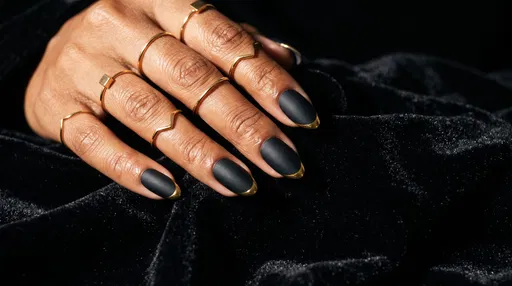 Matte Black and Gold Almond Nails