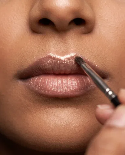 Applying Shimmer Highlighter to Lips Close-Up