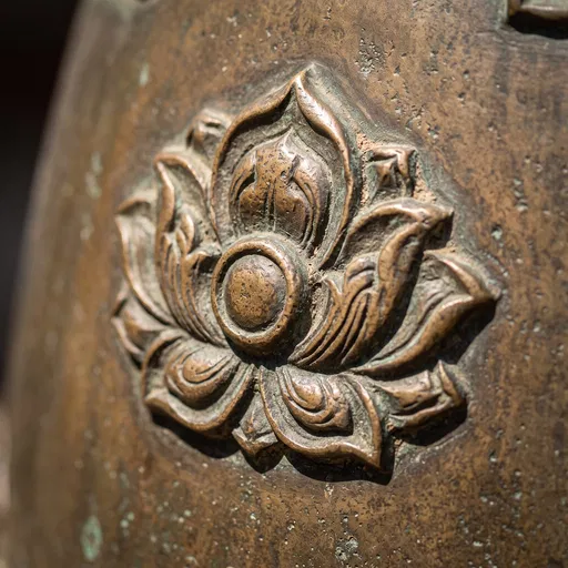 Ornate Bronze Bell Lotus Relief Macro