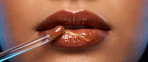 Macro of Glossy Terracotta Lips with Applicator