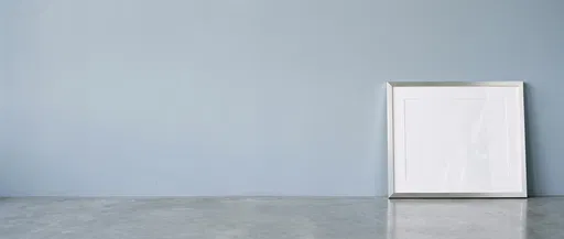 Silver Frame Leaning Against Blue Wall