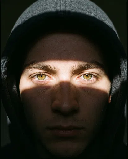 Close-Up Portrait of Hooded Man with Hazel Eyes