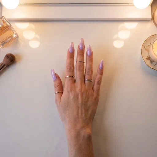 Hand With Pastel Lilac Glitter Nails
