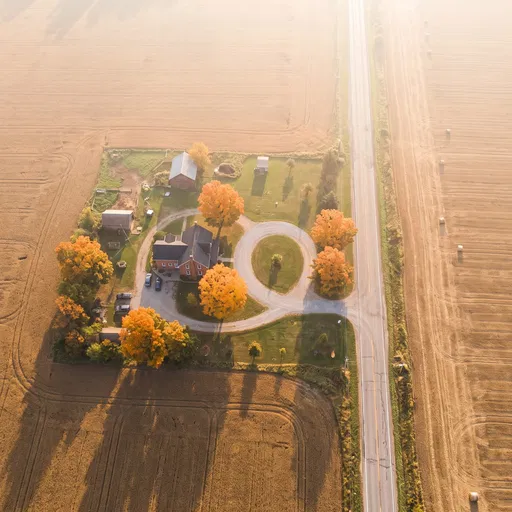 Aerial View of Farmhouse in Autumn Fields