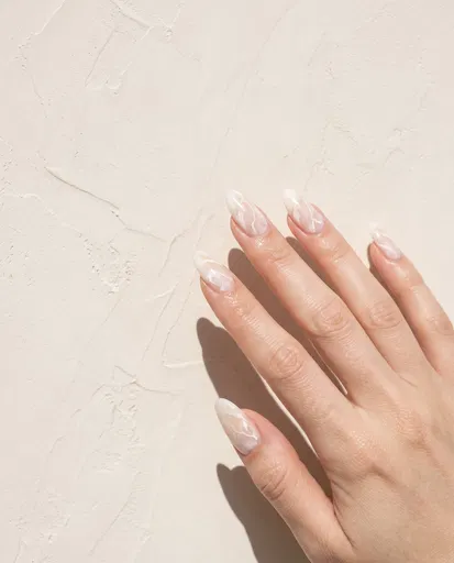 Hand With White Marble Almond Nails