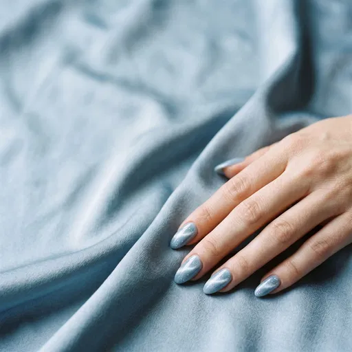 Hand With Blue Cat-Eye Almond Nails