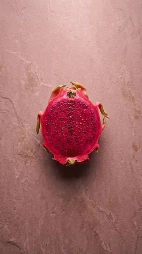 Halved Red Dragon Fruit on Pink Stone