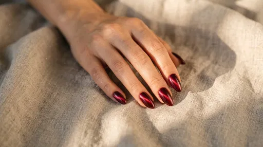 Hand With Burgundy Cat Eye Nails