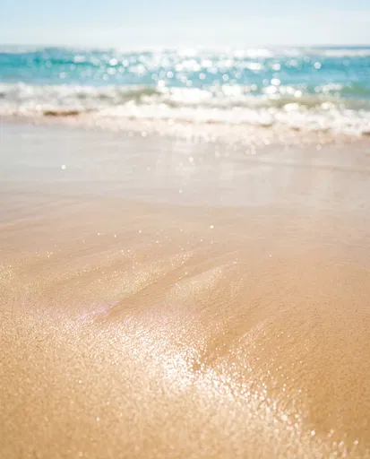 Sunlit Wet Beach Sand and Ocean Bokeh