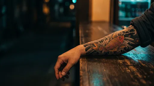 Tattooed Forearm Resting on Wooden Counter