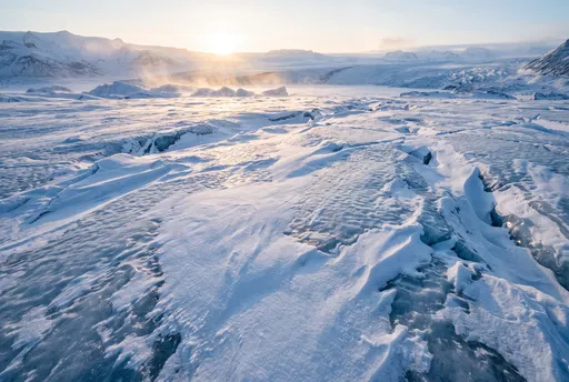 Sunlit Glacial Ice Landscape at Dawn