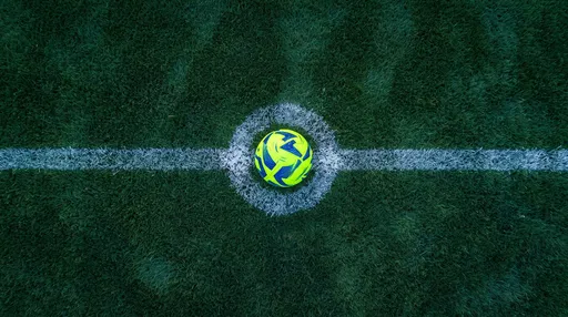 Overhead Neon Soccer Ball on Grass Pitch