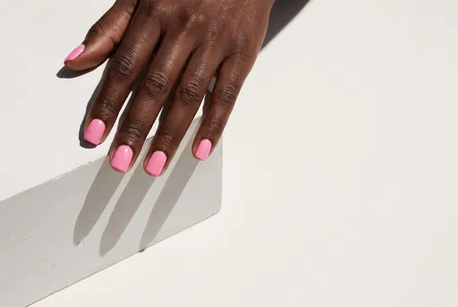 Hand With Pink Nails on White Block