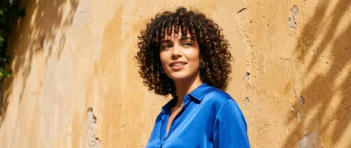 Woman with Curly Bob in Blue Blouse