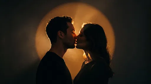 Couple Kissing in Warm Spotlight Silhouette