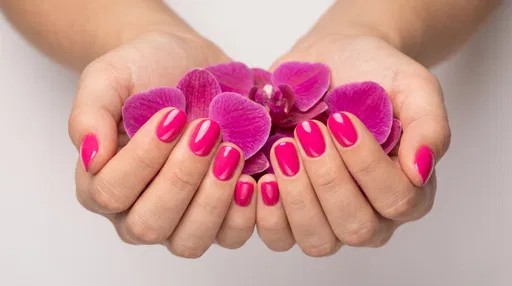 Hands With Hot Pink Nails Holding Orchid