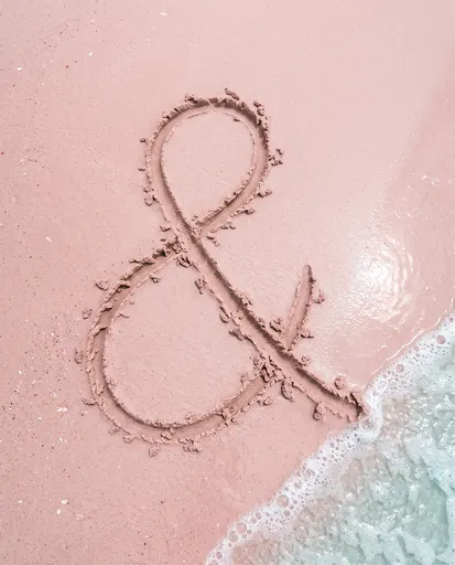 Ampersand Drawn in Pink Beach Sand
