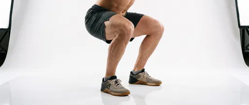 Athlete Performing Bodyweight Squat in Studio