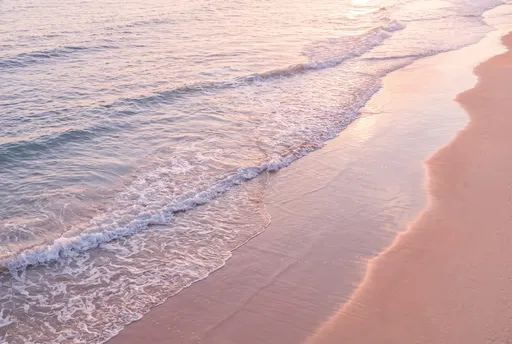 Pastel Sunset Waves on Coral Sand