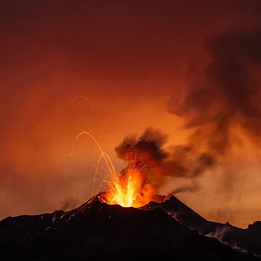Erupting Volcano Silhouette Against Crimson Sky