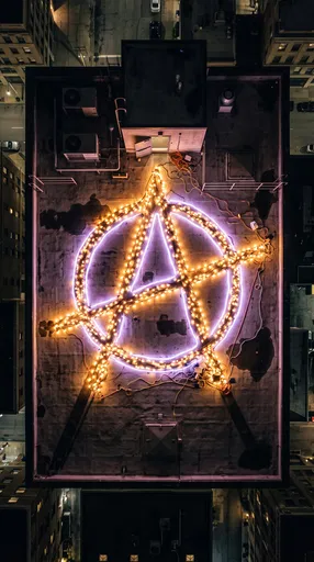 Glowing Anarchy Symbol on Night Rooftop