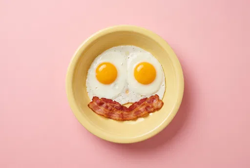 Smiling Breakfast Eggs and Bacon in Bowl