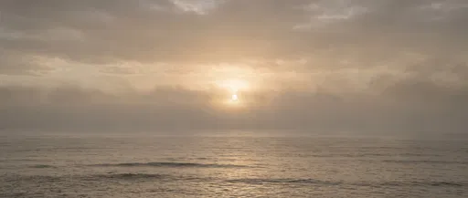 Misty Sunset Over Calm Ocean