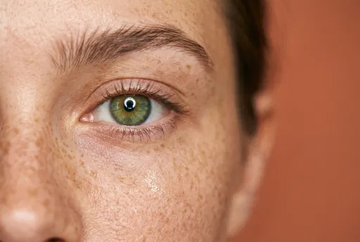 Macro Green Eye With Freckled Skin