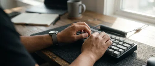 Hands Typing on Minimalist Mechanical Keyboard