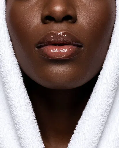 Close-Up of Glossy Lips in White Robe