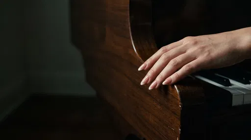 Hand With Almond Manicure On Piano