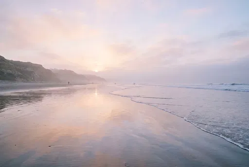 Pastel Sunrise Over Misty California Beach
