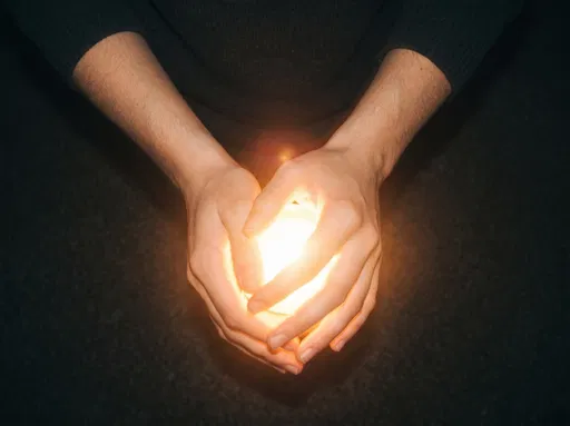 Hands Cupping Warm Glowing Light