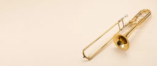 Gold Trombone on Cream Studio Backdrop