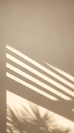 Warm Sunlight Shadows on Beige Plaster Wall