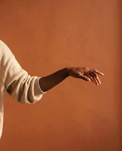 Arm Reaching Out on Terracotta Background