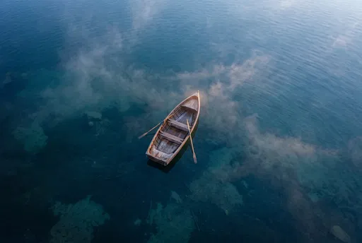 Aerial View of Wooden Rowboat on Misty Lake